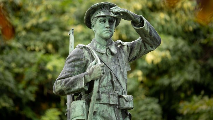 The top of a statue of a saluting soldier