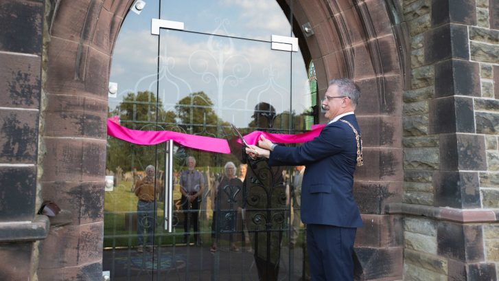 Town Mayor cuts a ribbon to open the cemetery chapel