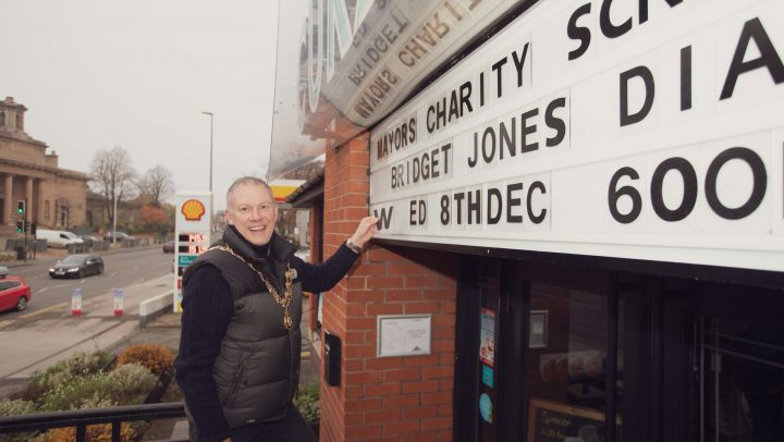 The Town Mayor adds the letters to the screening notice at the cinema