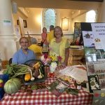 Volunteers from Knutsford Allotment Society at a stall in a church in 2021