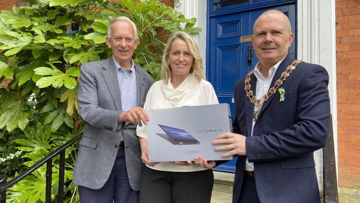 David Biggs and Nichola Marshall of Knutsford Together receive a laptop from the Town Mayor