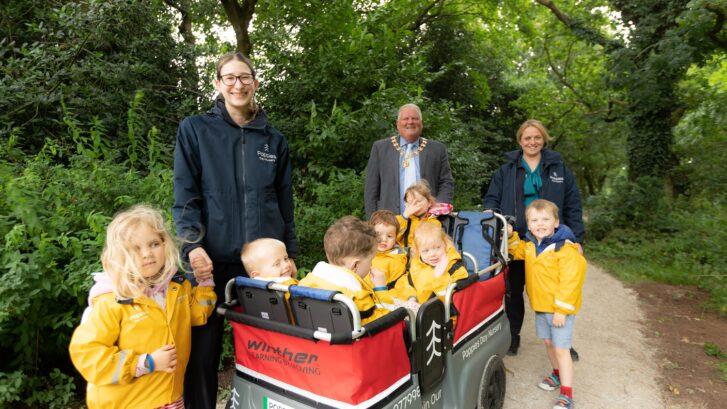 Town Mayor Cllr Colin Banks with staff and children from Poppies Nursery