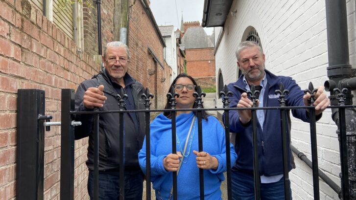 Cllrs Peter Coan, April Johnson and James McCulloch behind a gate