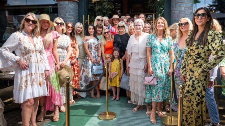 A group of people stood in front of a building.