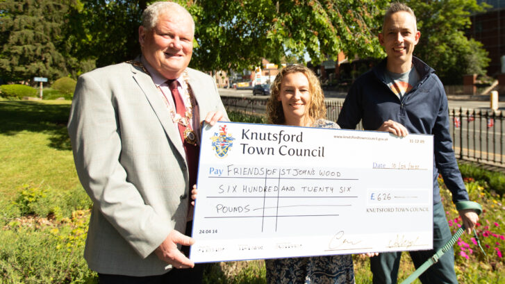 Cathryn Walley and Geraint Samuels from Friends of St John's Wood stood with Mayor Colin Banks with £626 cheque.