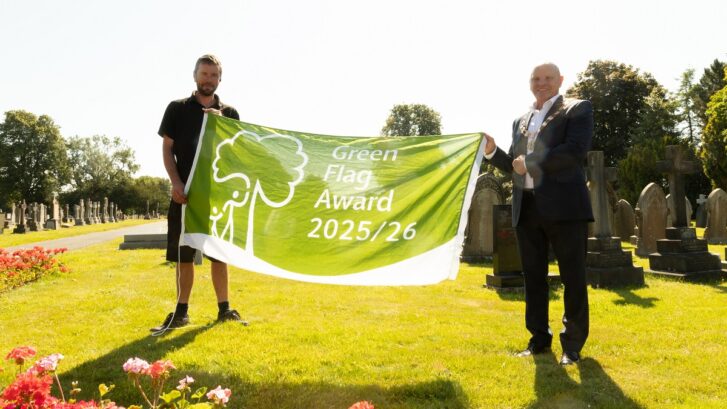 Fergal Owen and the Town Mayor hold the Green Flag