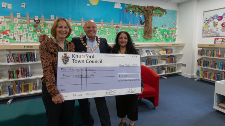 Anne Sherman, Bryan Hartley and Shazia Janjua stood holding a large cheque for £400.