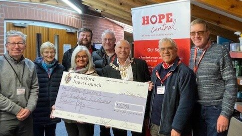 Town Mayor Bryan Hartley and Barney Howard of Hop Central stood with their volunteers with the cheque for the grant.