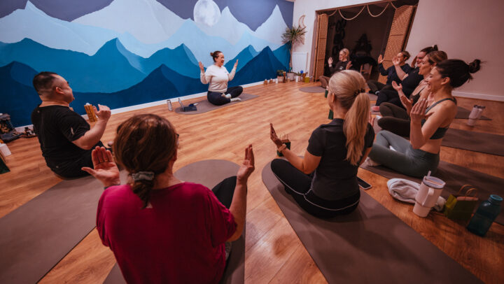 Charlotte Montgomery from Satya Sanctuary sat on the floor leading a Yoga class.