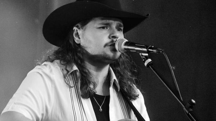 Jake O'Neill singing at the microphone