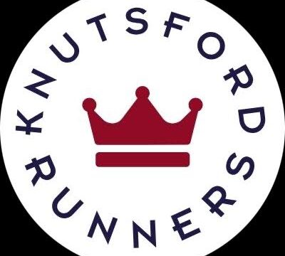 The logo for Knutsford Runners, showcasing a red crown icon and the name prominently displayed in a circle around it.