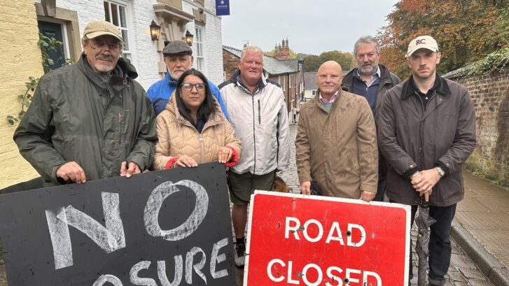 Angry Councillors stood on a road objecting to a road closure