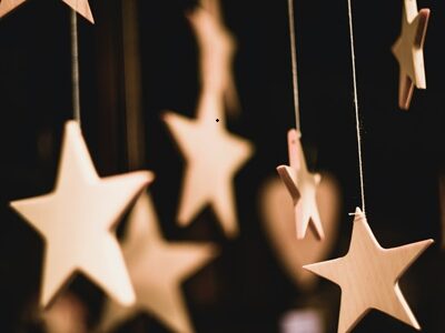 Wooden Stars 2 Wooden stars dangling with a black background